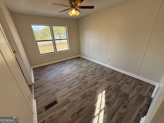 wooden floor in an empty room with a window
