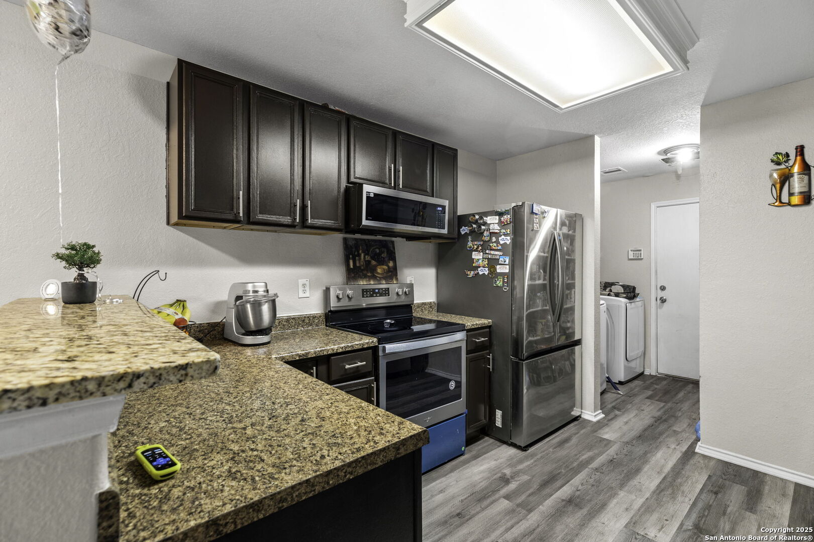 6931 Pecan Converse, TX 78109 - Photo 11 of 25 a kitchen with stainless steel appliances granite countertop a sink stove and refrigerator
