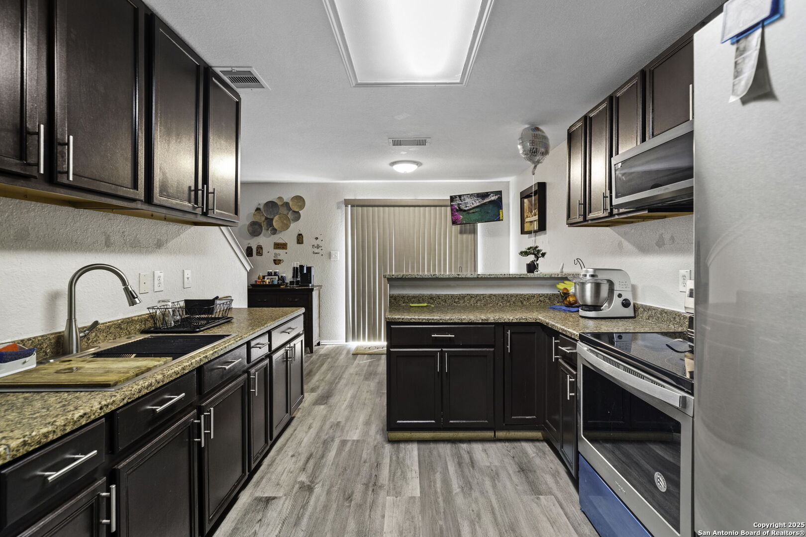 6931 Pecan Converse, TX 78109 - Photo 12 of 25 a kitchen with stainless steel appliances granite countertop a stove and a sink