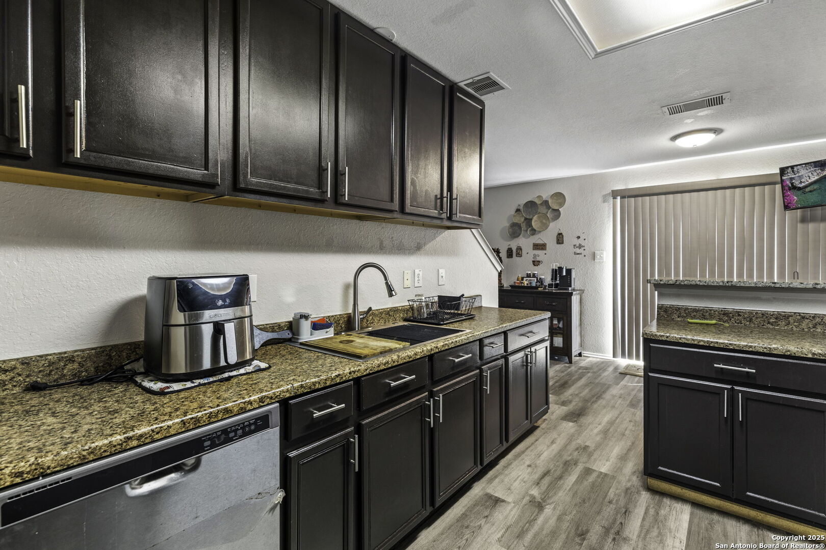 6931 Pecan Converse, TX 78109 - Photo 13 of 25 a kitchen with stainless steel appliances granite countertop a sink stove and refrigerator