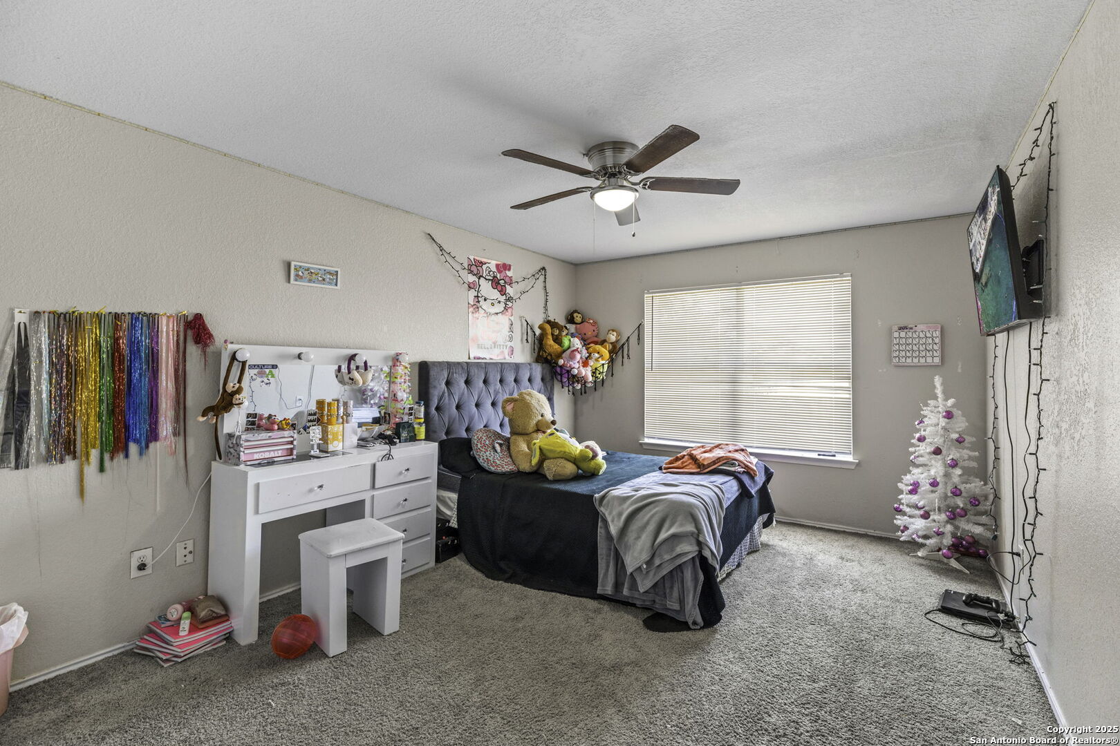 6931 Pecan Converse, TX 78109 - Photo 17 of 25 a bedroom with furniture a flat screen tv and a window