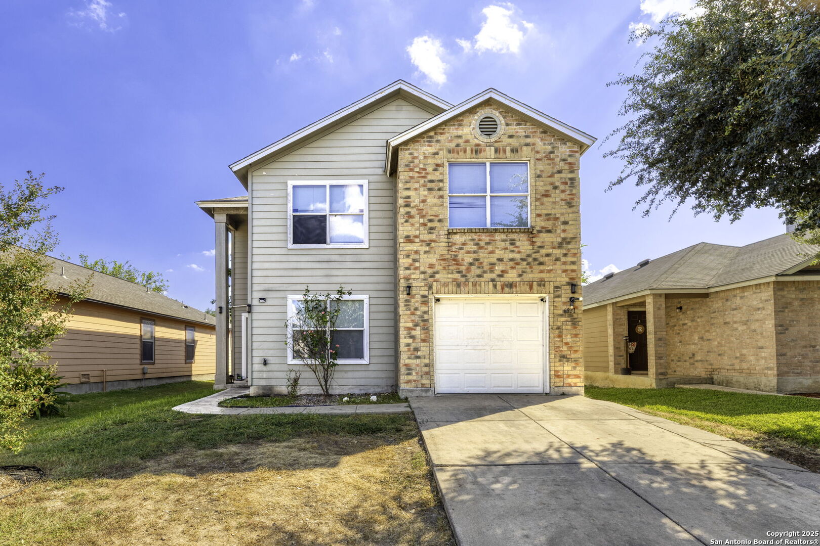 6931 Pecan Converse, TX 78109 - Photo 2 of 25 a front view of a house with a garden and yard