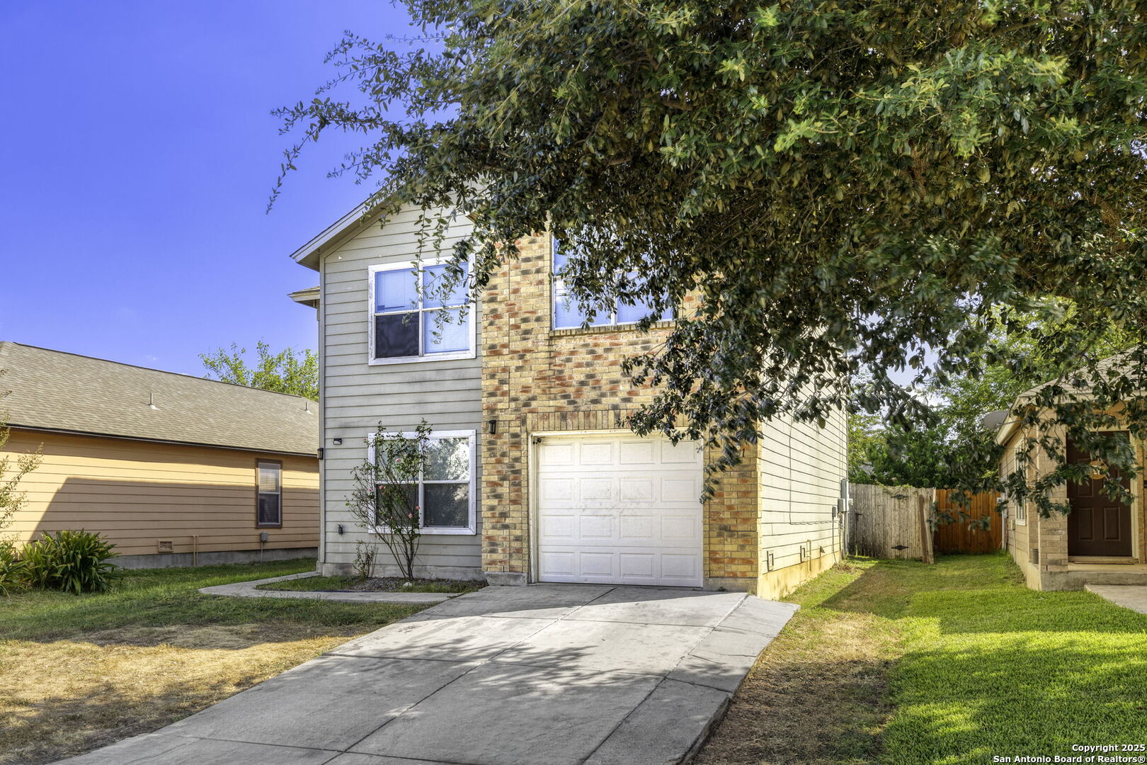 6931 Pecan Converse, TX 78109 - Photo 3 of 25 a front view of house with yard and trees in the background