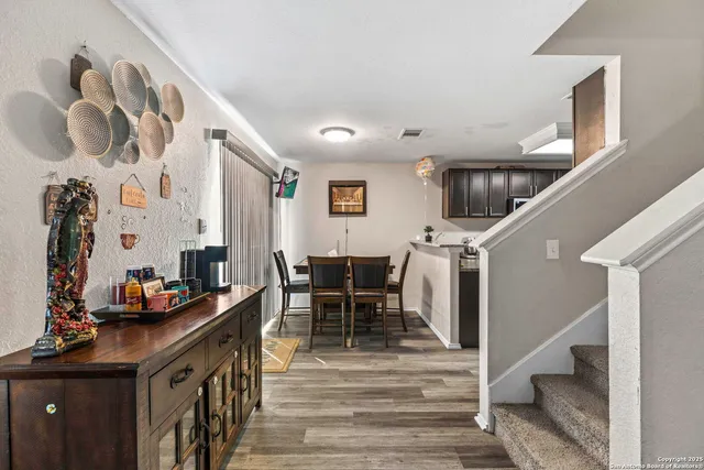 a dining room with furniture and wooden floor