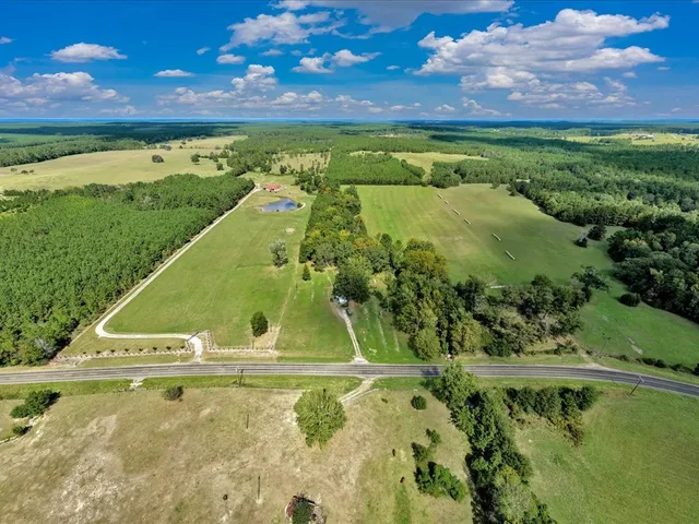 a view of a swimming pool with a yard
