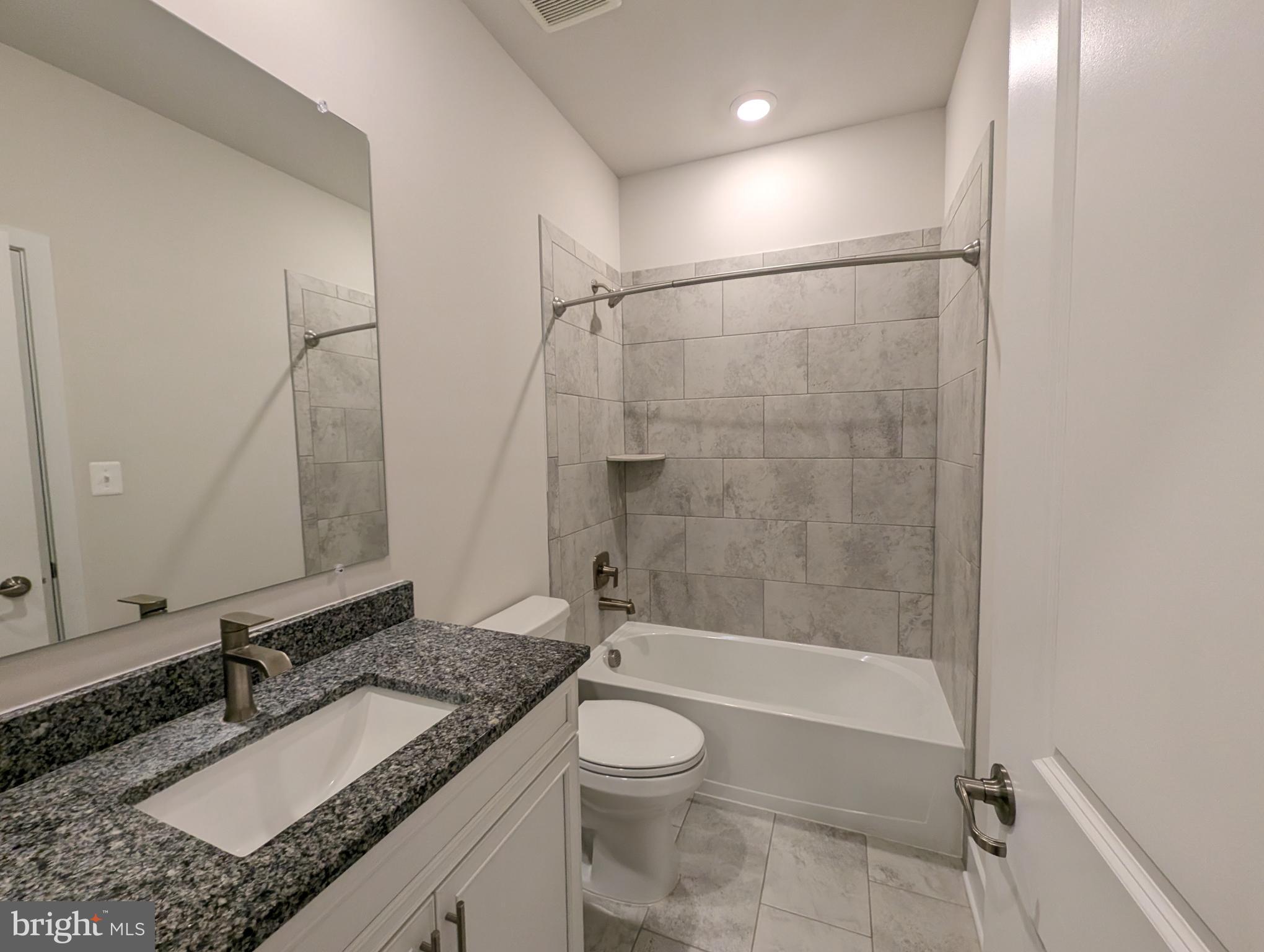 52 Tulip Tree Way Gettysburg, PA 17325 - Photo 22 of 24 a bathroom with a granite countertop sink toilet mirror and shower