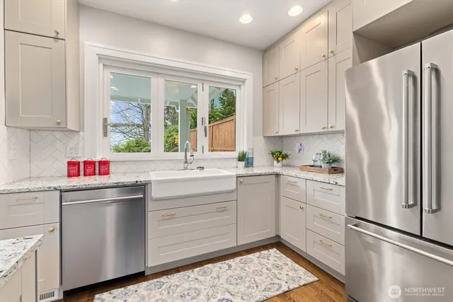 a kitchen with white cabinets sink and refrigerator