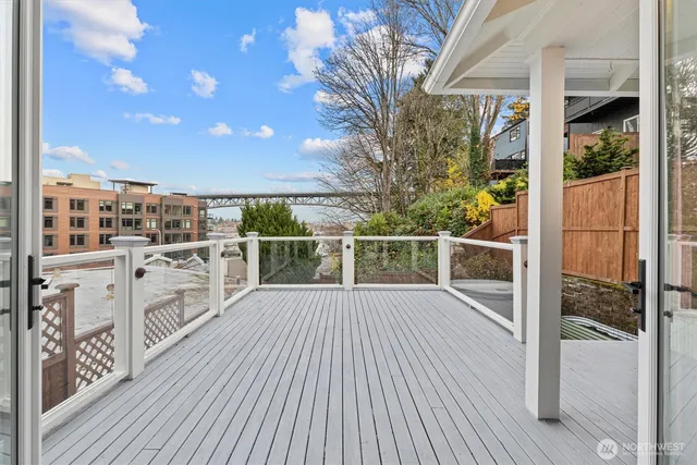 a view of roof deck with wooden floor and fence