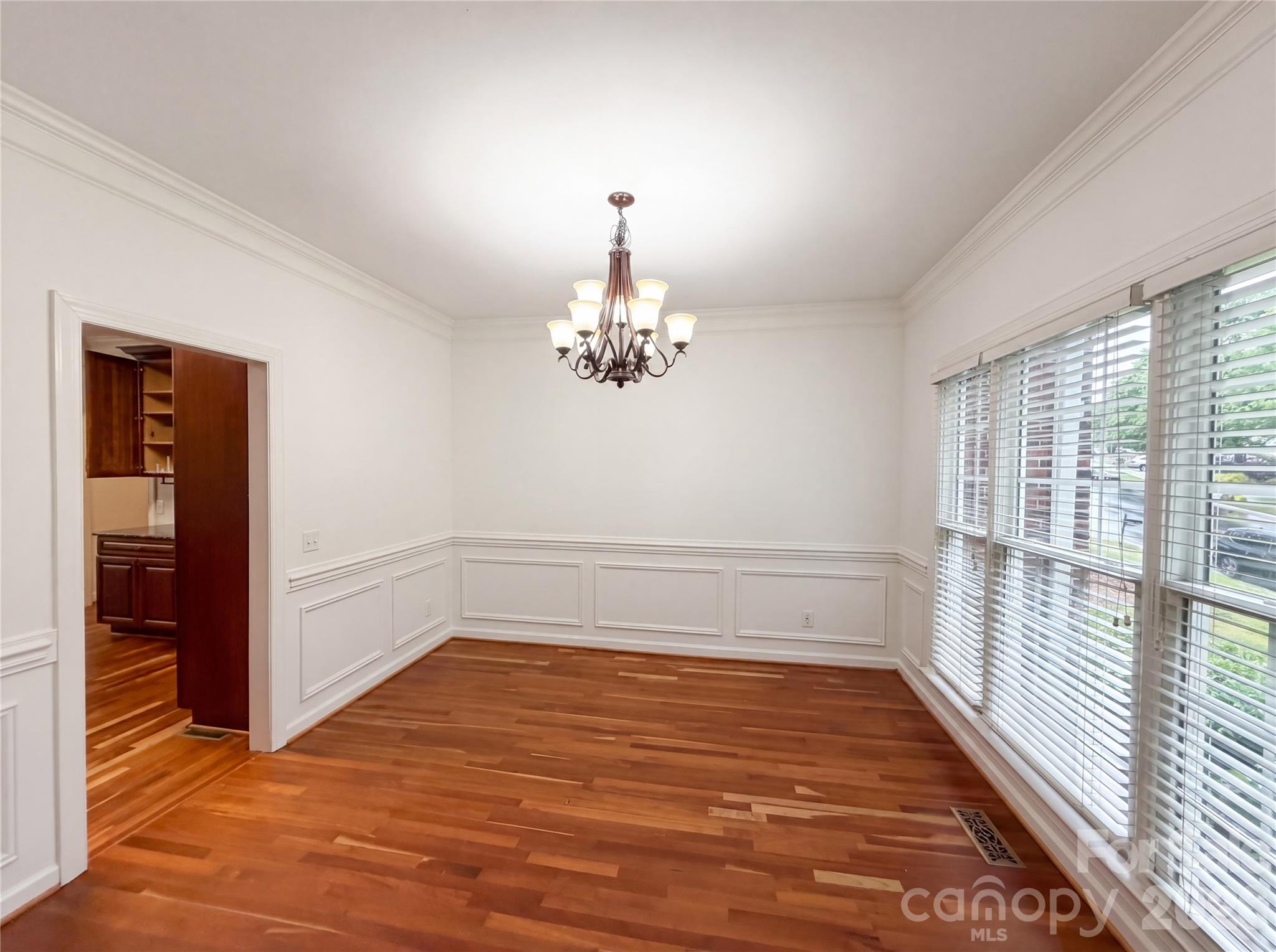 12341 Willingdon Road Huntersville, NC 28078 - Photo 6 of 17 wooden floor in an empty room with a window