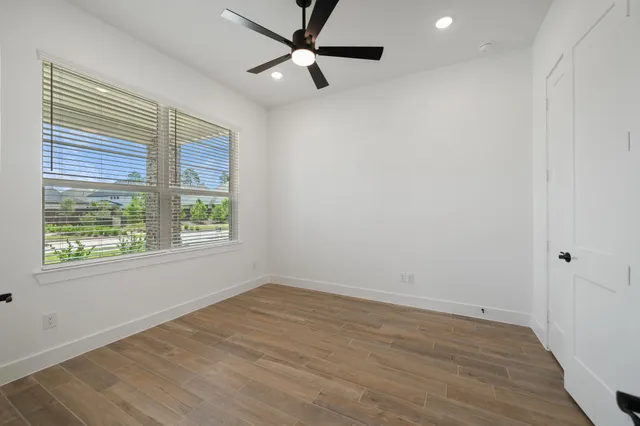 wooden floor in an empty room with a window