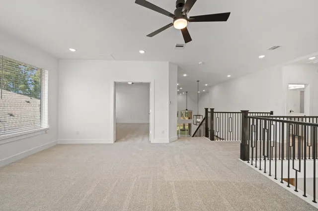 a view of a hallway with a ceiling fan
