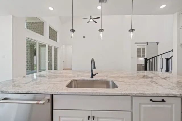 a kitchen with a sink and a refrigerator