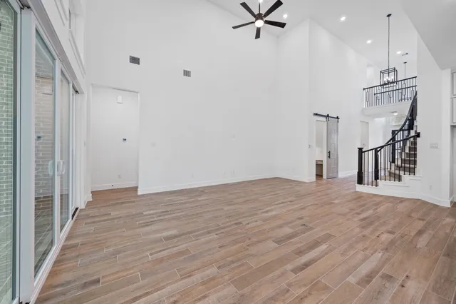 a view of a livingroom with a hardwood floor and staircase