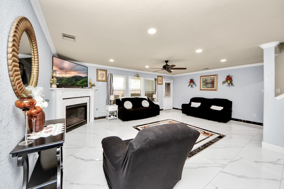 10207 Moonset Lane Houston, TX 77016 - Photo 11 of 34 a living room with furniture a flat screen tv and a fireplace