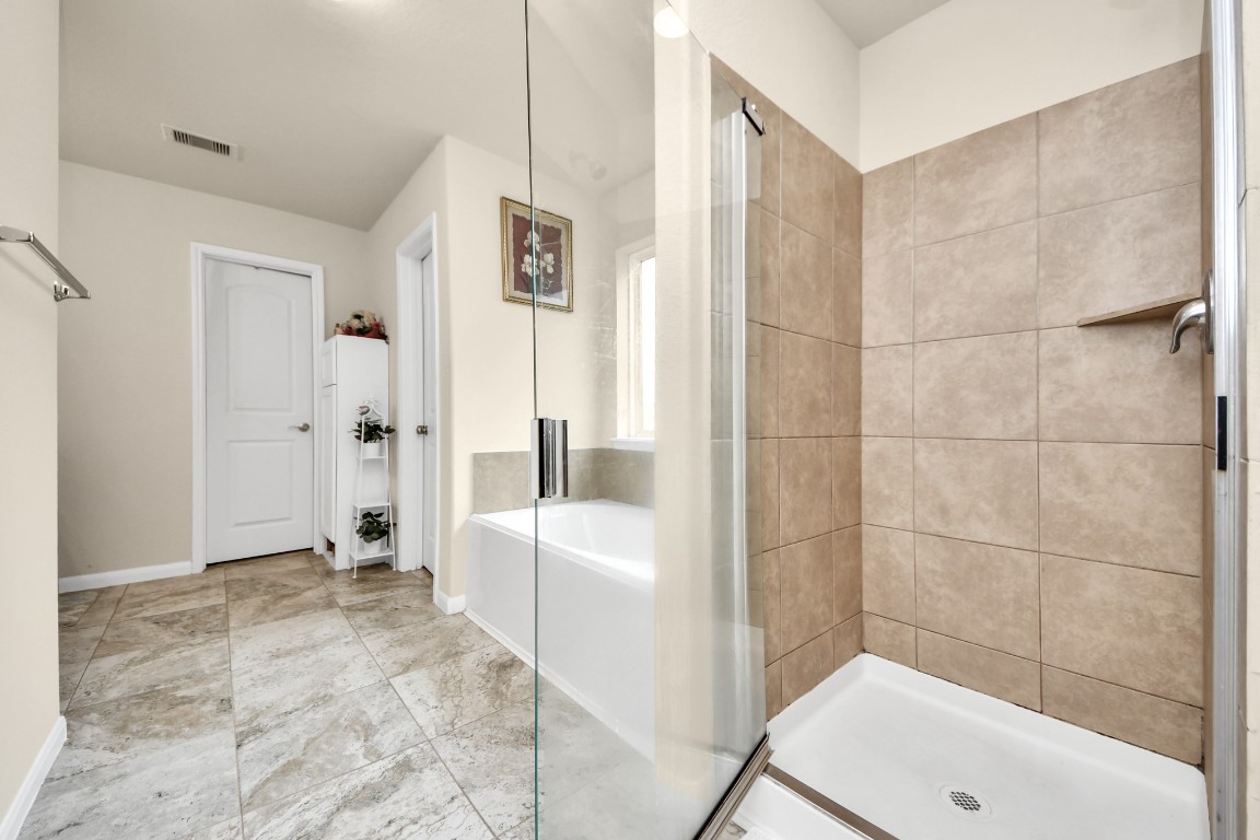 10207 Moonset Lane Houston, TX 77016 - Photo 16 of 34 a bathroom with a tub shower and toilet