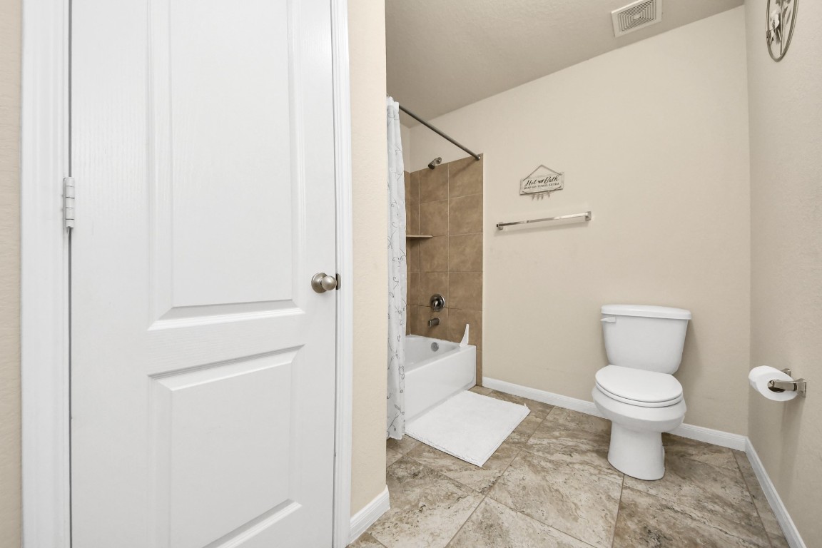 10207 Moonset Lane Houston, TX 77016 - Photo 20 of 34 a bathroom with a toilet and a shower