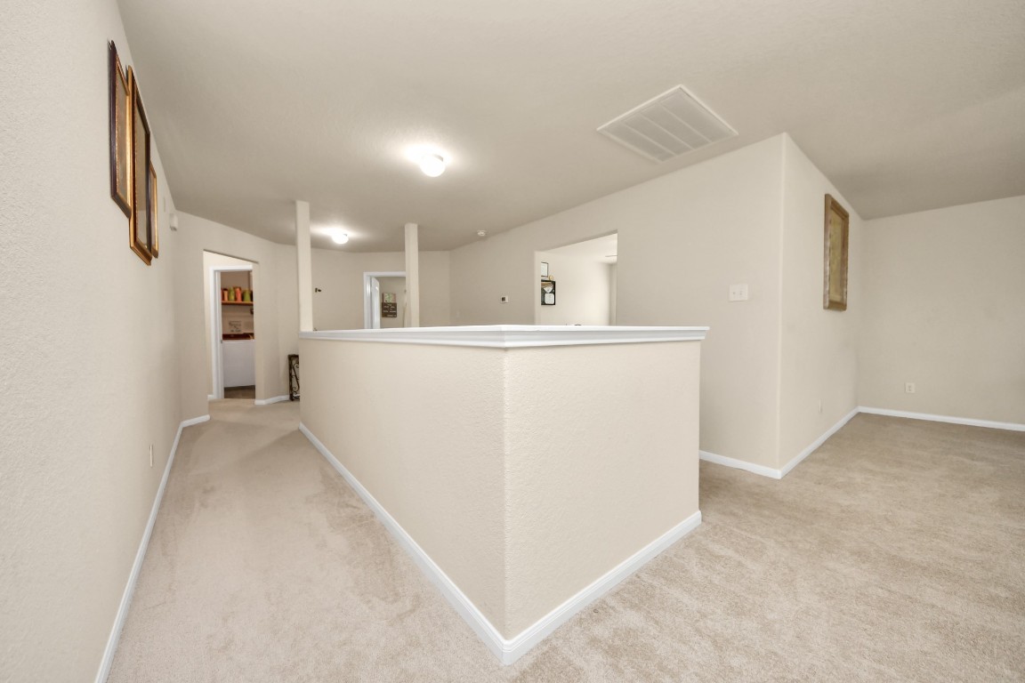 10207 Moonset Lane Houston, TX 77016 - Photo 24 of 34 a view of a kitchen with refrigerator and white walls