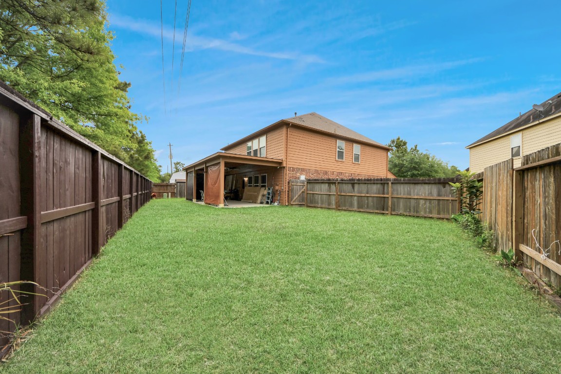 10207 Moonset Lane Houston, TX 77016 - Photo 31 of 34 a view of a house with backyard and garden