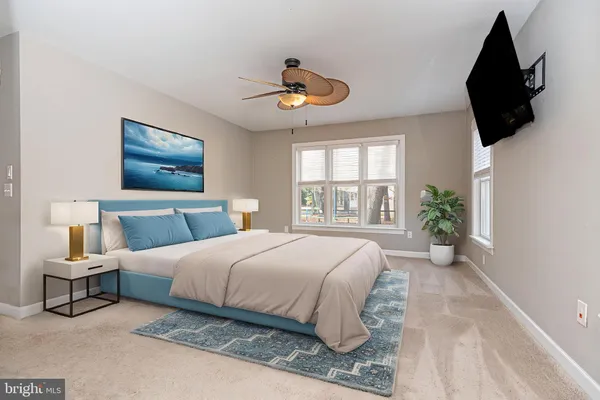 a bedroom with a large bed and a window