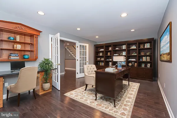 a living room with furniture and a book shelf