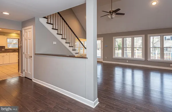 wooden floor in an empty room with a window and wooden floor
