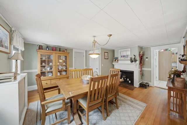 a dining room with furniture and wooden floor