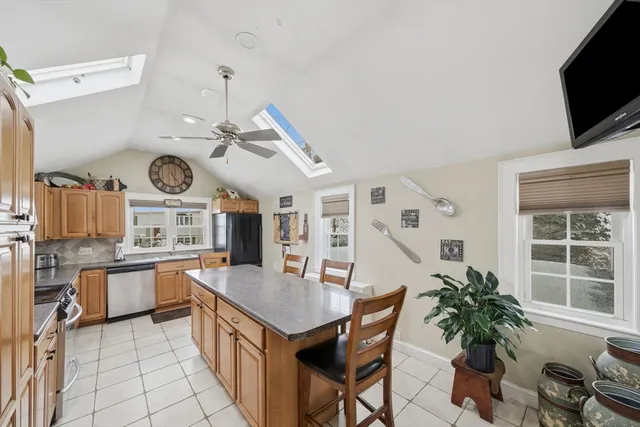a kitchen with granite countertop a table and chairs in it
