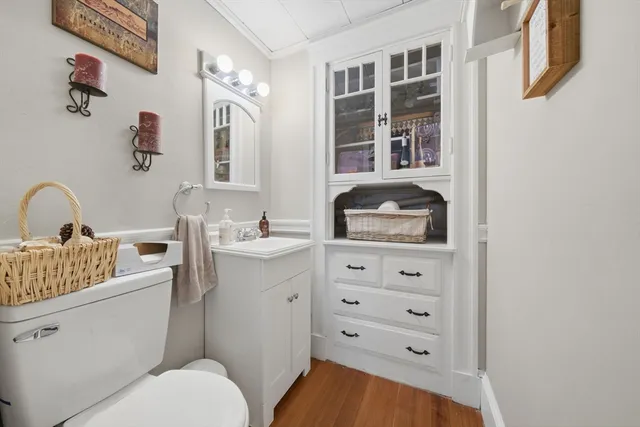 a bathroom with a toilet a sink and a mirror