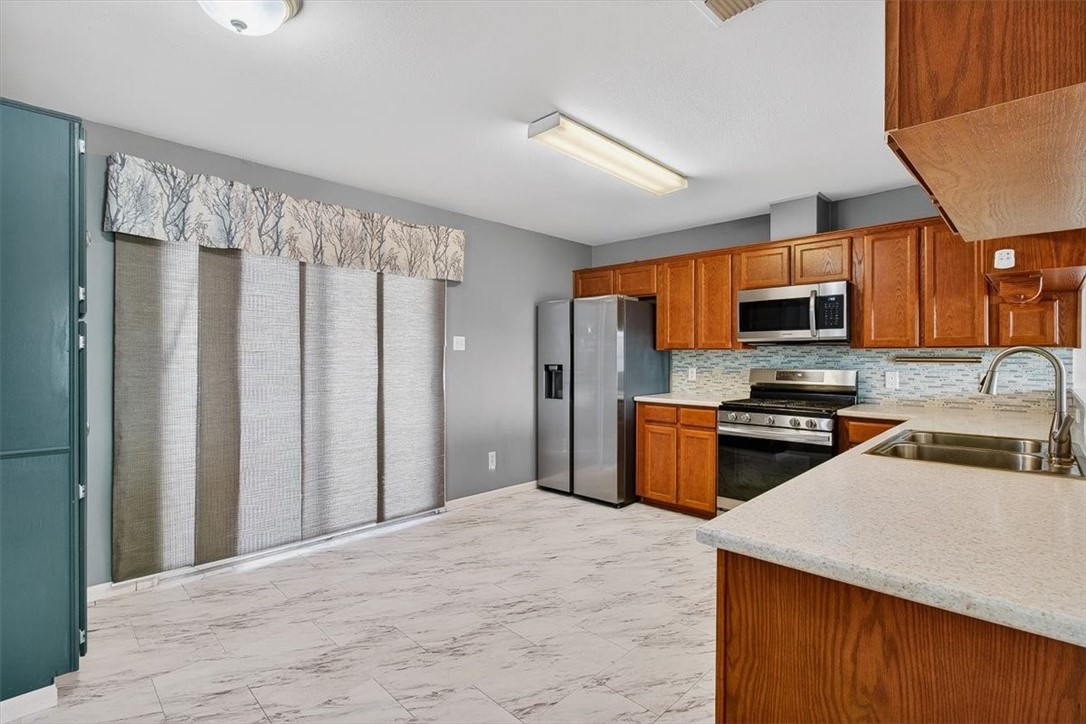 850 Purdue Road Corpus Christi, TX 78418 - Photo 14 of 39 a kitchen with stainless steel appliances granite countertop a refrigerator a stove top oven a sink and dishwasher