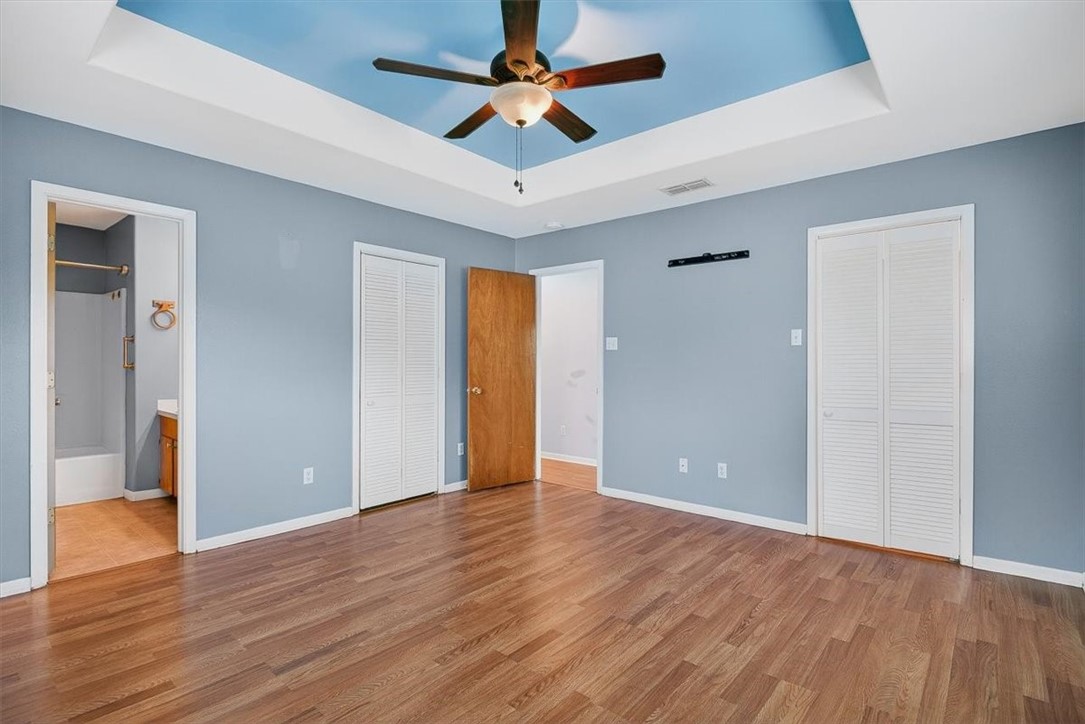 850 Purdue Road Corpus Christi, TX 78418 - Photo 19 of 39 a view of an empty room with window a ceiling fan and wooden floor