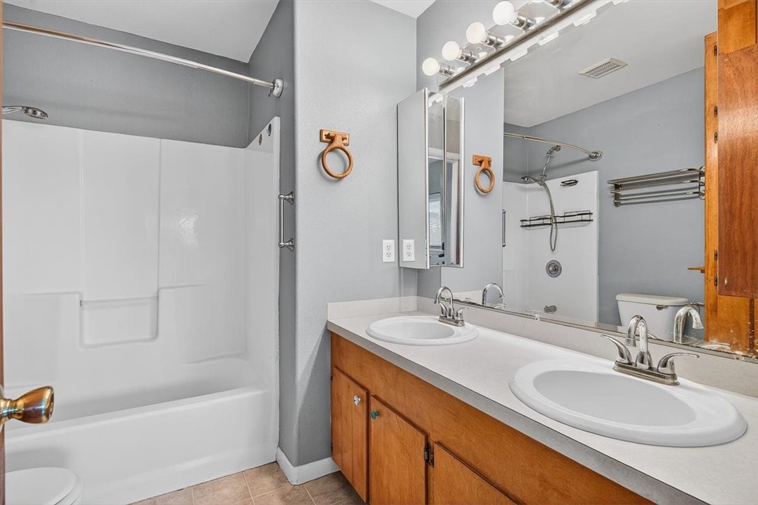 850 Purdue Road Corpus Christi, TX 78418 - Photo 21 of 39 a bathroom with a granite countertop sink mirror and a bathtub