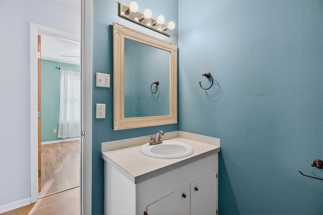 850 Purdue Road Corpus Christi, TX 78418 - Photo 28 of 39 a bathroom with a sink vanity and a mirror
