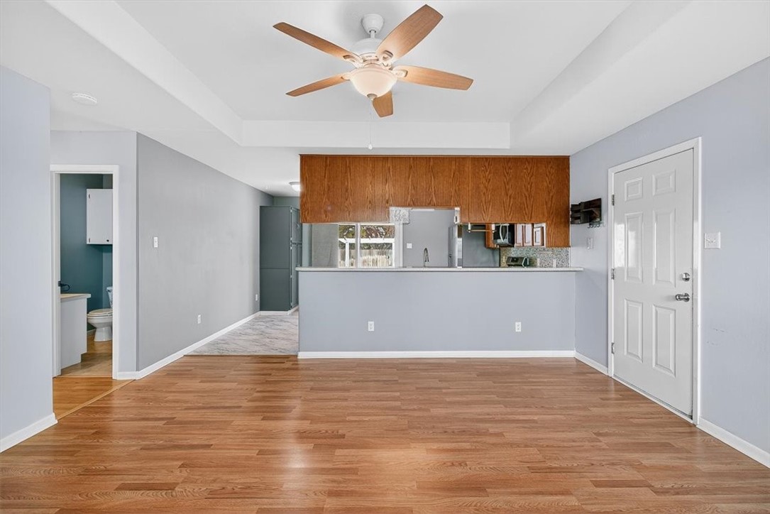 850 Purdue Road Corpus Christi, TX 78418 - Photo 31 of 39 a view of a big room with wooden floor and a ceiling fan