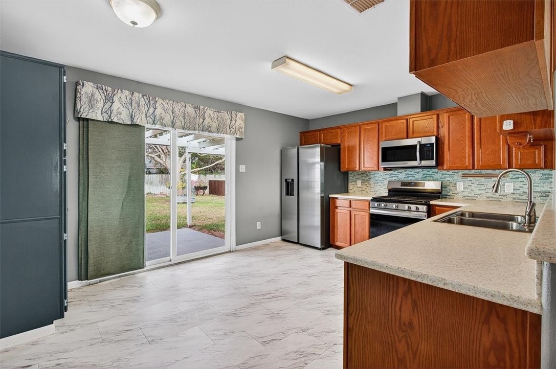 850 Purdue Road Corpus Christi, TX 78418 - Photo 10 of 39 a kitchen with stainless steel appliances granite countertop a refrigerator stove and oven