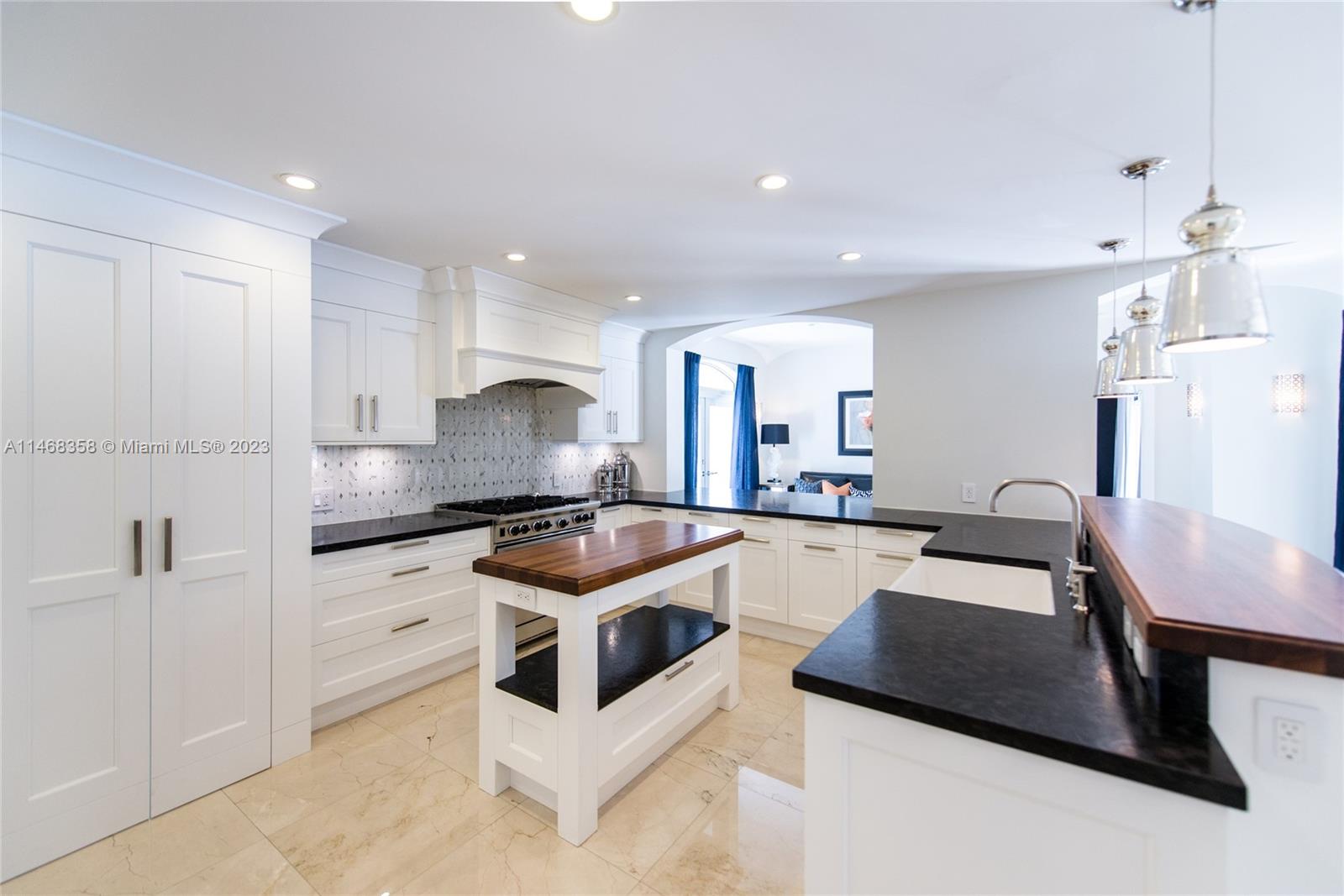 3500 Munroe Drive Coconut Grove, FL 33133 - Photo 12 of 54 a kitchen with granite countertop a sink a counter space appliances and cabinets