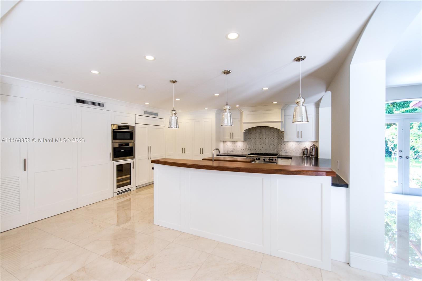 3500 Munroe Drive Coconut Grove, FL 33133 - Photo 13 of 54 a large kitchen with stainless steel appliances granite countertop a stove and a refrigerator