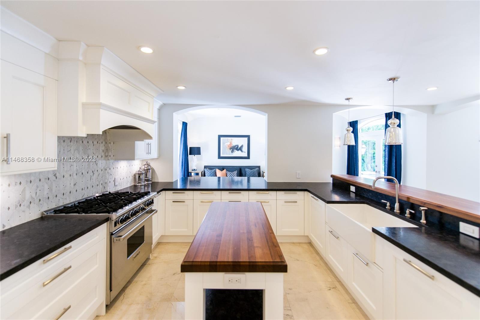 3500 Munroe Drive Coconut Grove, FL 33133 - Photo 14 of 54 a large kitchen with stainless steel appliances a large counter top a stove and a refrigerator