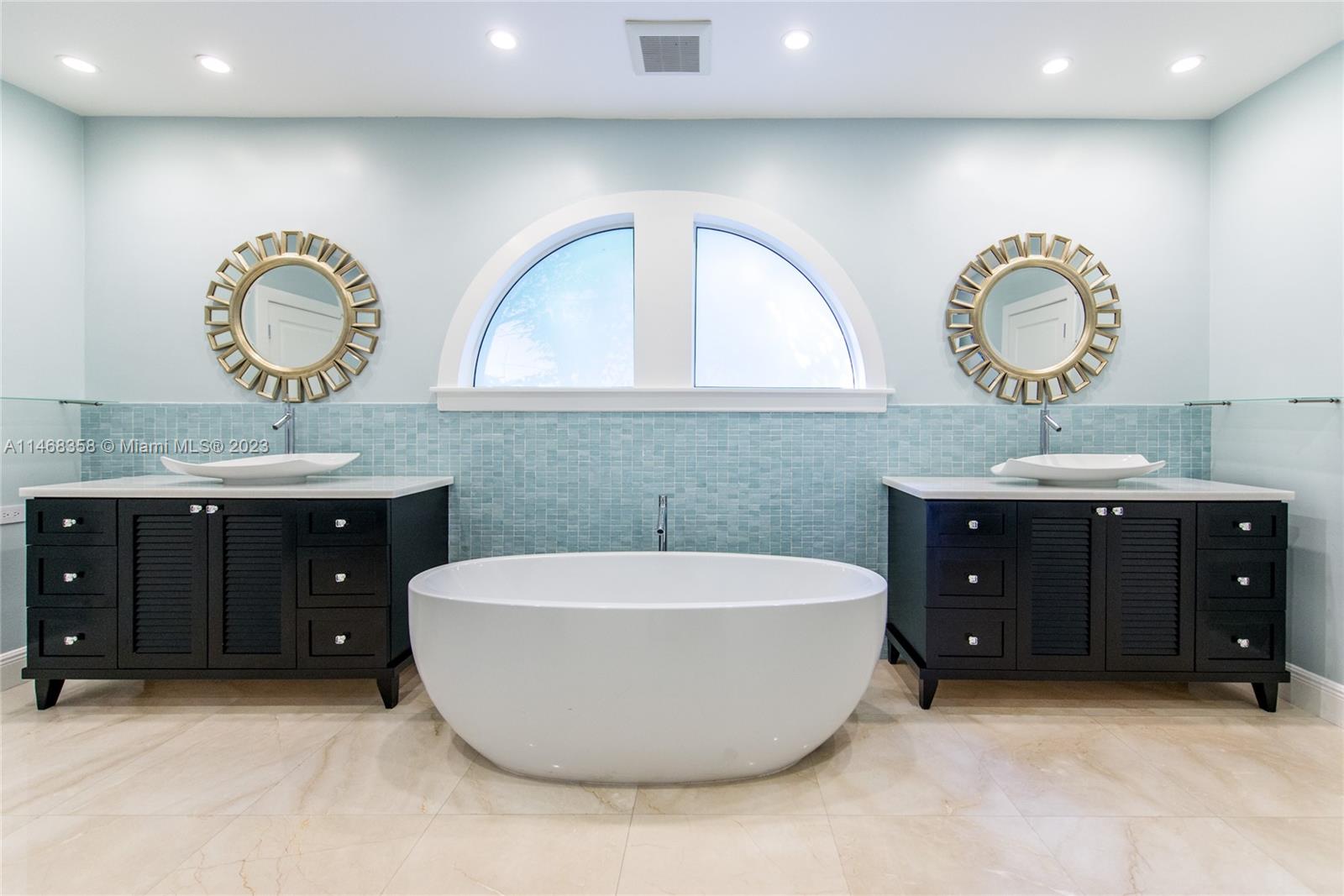 3500 Munroe Drive Coconut Grove, FL 33133 - Photo 29 of 54 a spacious bathroom with a tub sink and mirror