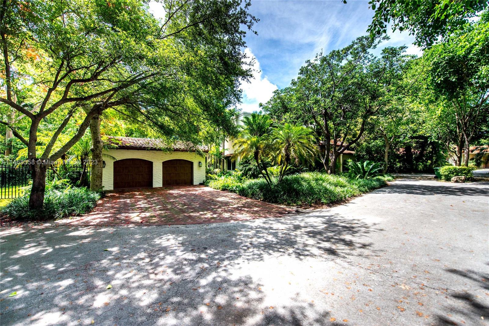 3500 Munroe Drive Coconut Grove, FL 33133 - Photo 3 of 54 a view of a house with a yard and large trees