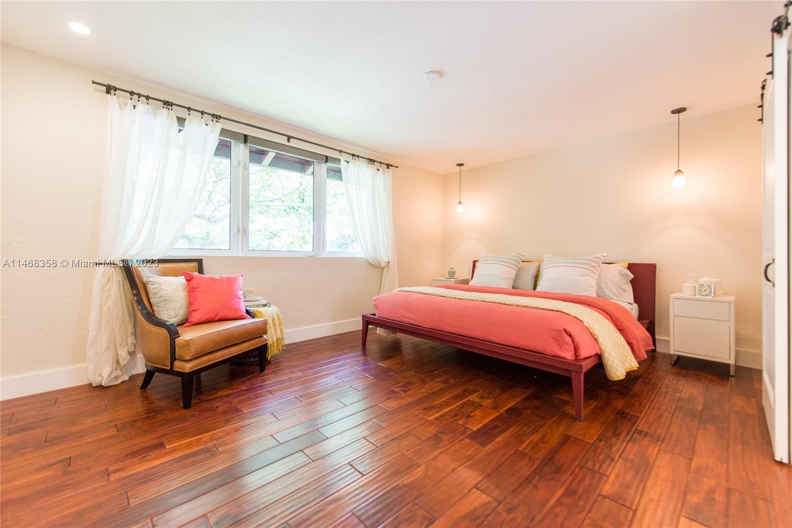 3500 Munroe Drive Coconut Grove, FL 33133 - Photo 32 of 54 a bedroom with a bed and wooden floor