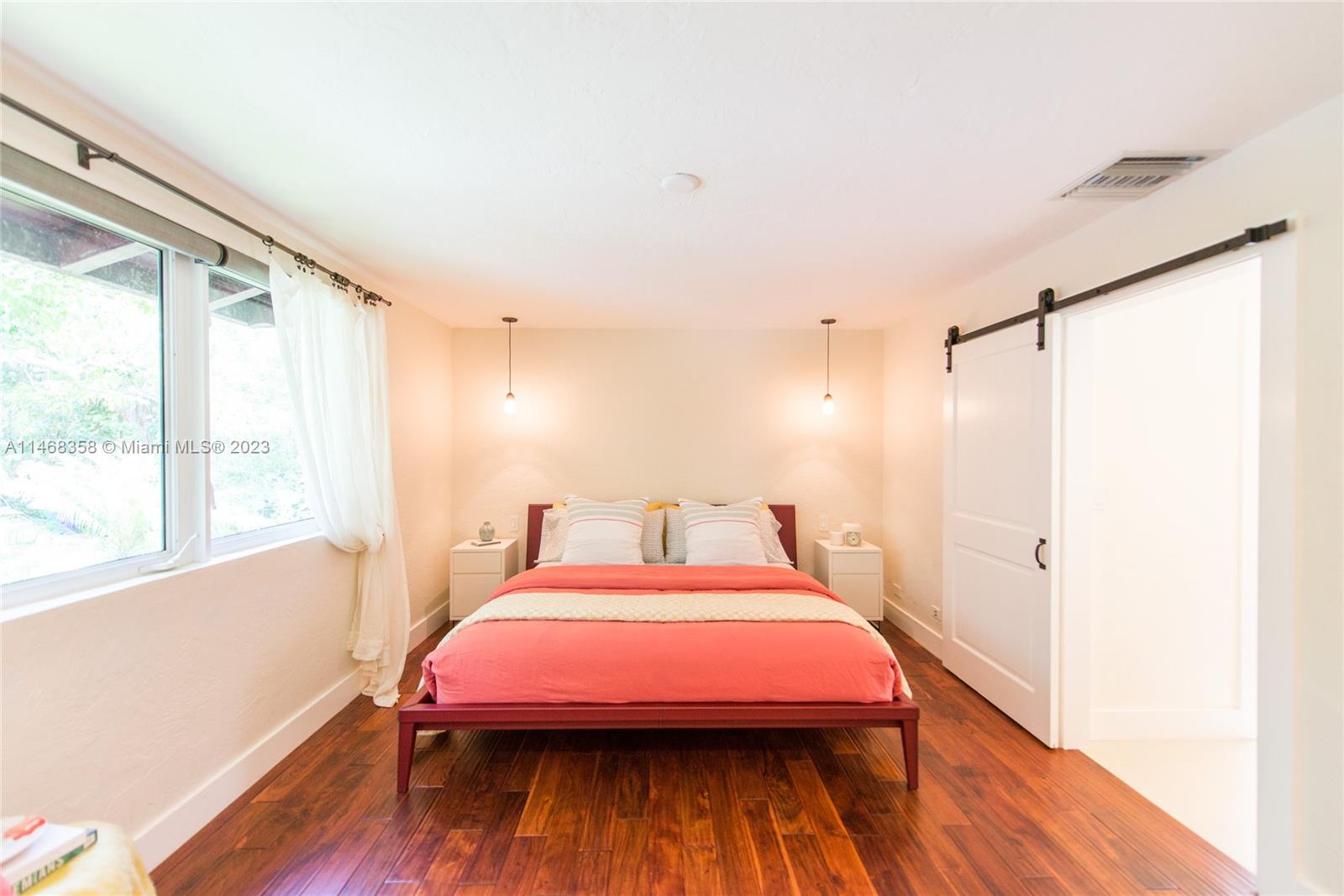 3500 Munroe Drive Coconut Grove, FL 33133 - Photo 33 of 54 a bedroom with a bed and a window