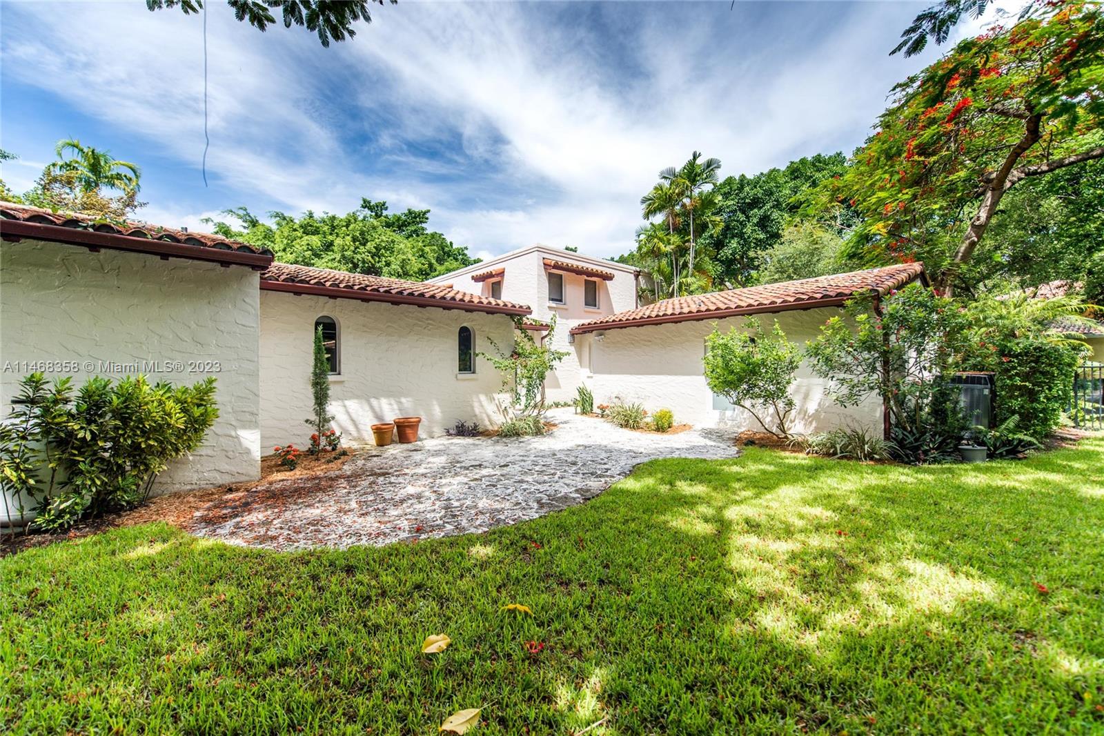 3500 Munroe Drive Coconut Grove, FL 33133 - Photo 43 of 54 a view of a backyard with a garden and plants