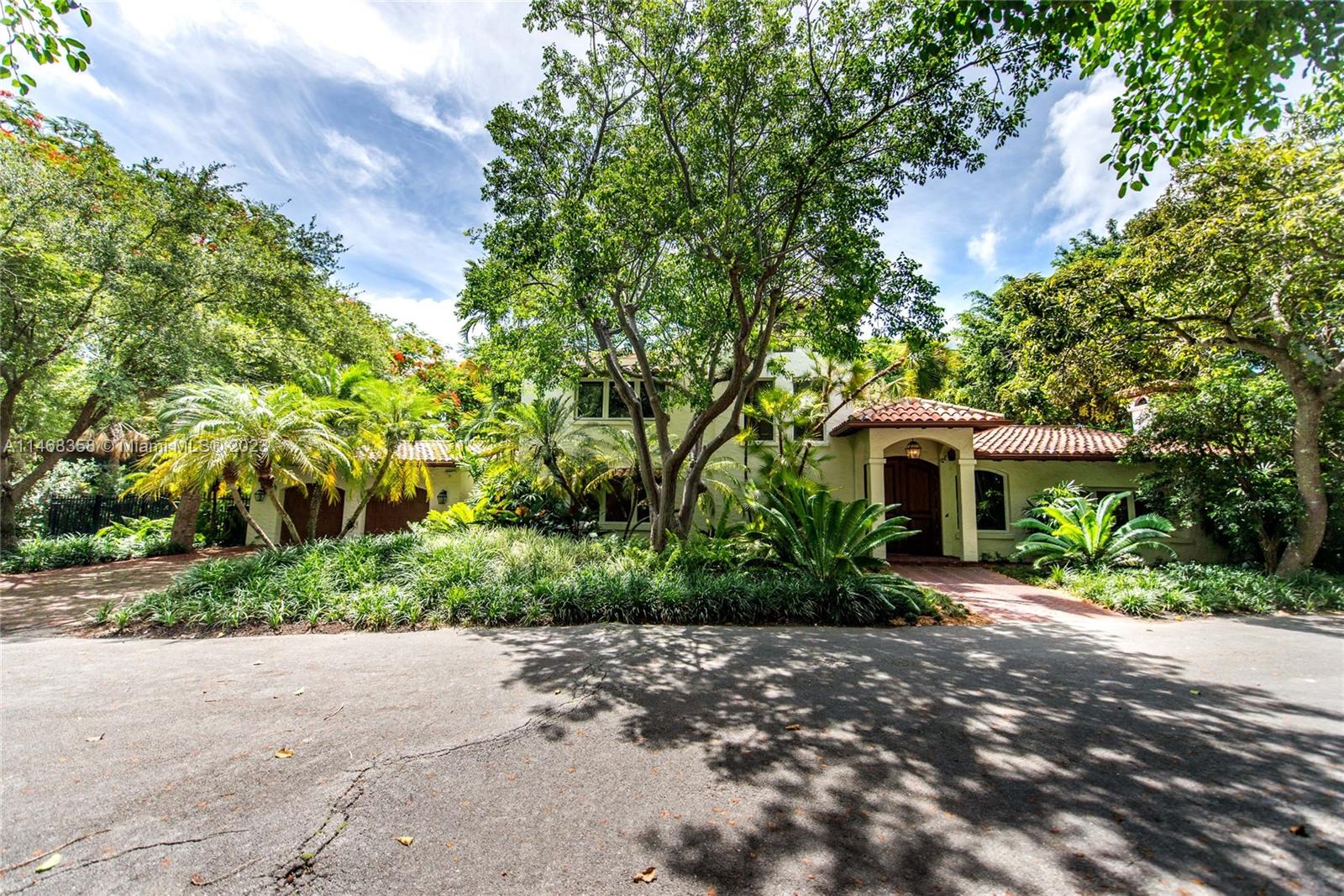 3500 Munroe Drive Coconut Grove, FL 33133 - Photo 48 of 54 a front view of a house with a yard and shrubs