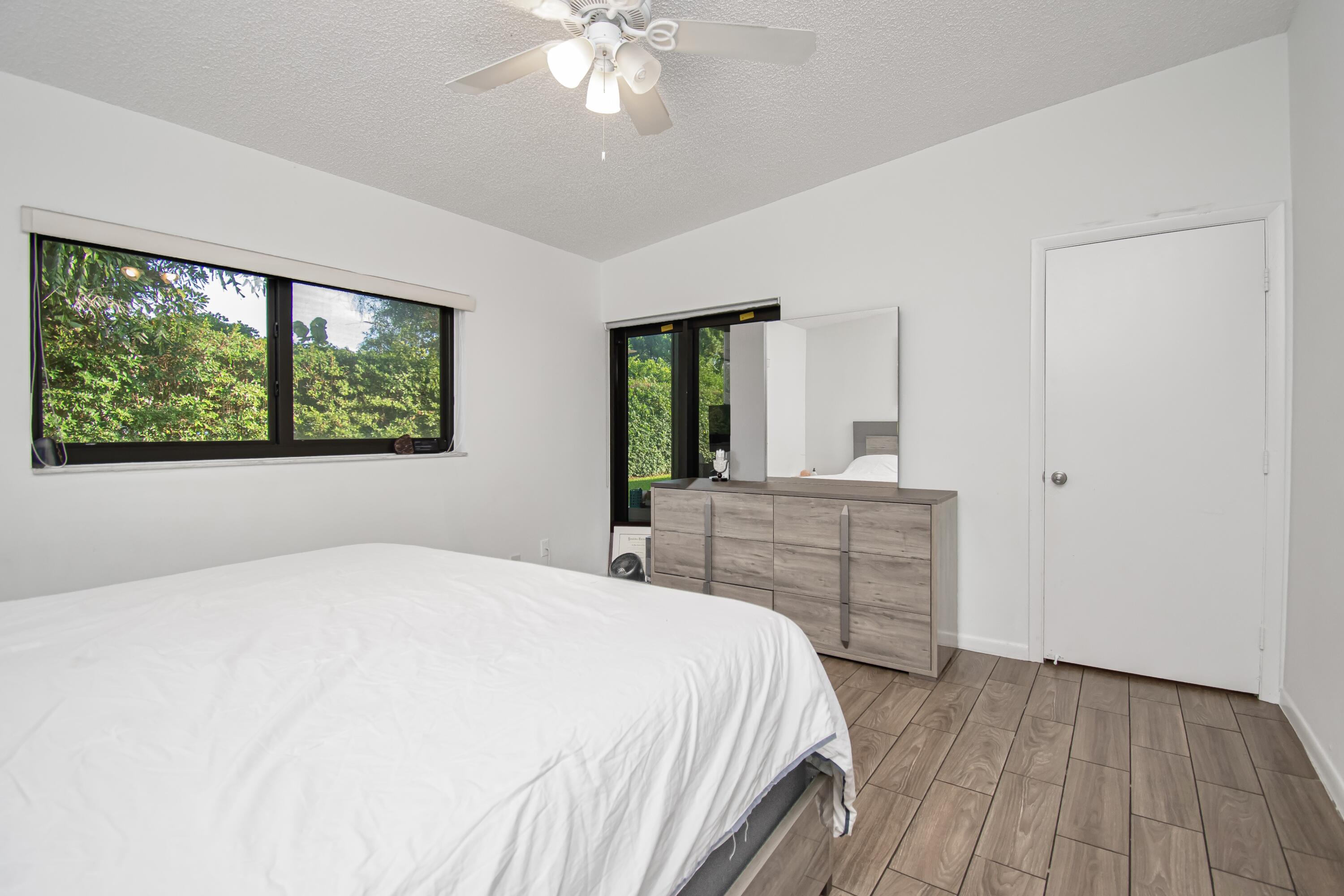 6825 Bridlewood Court Boca Raton, FL 33433 - Photo 17 of 31 a bedroom with a large bed and a dresser