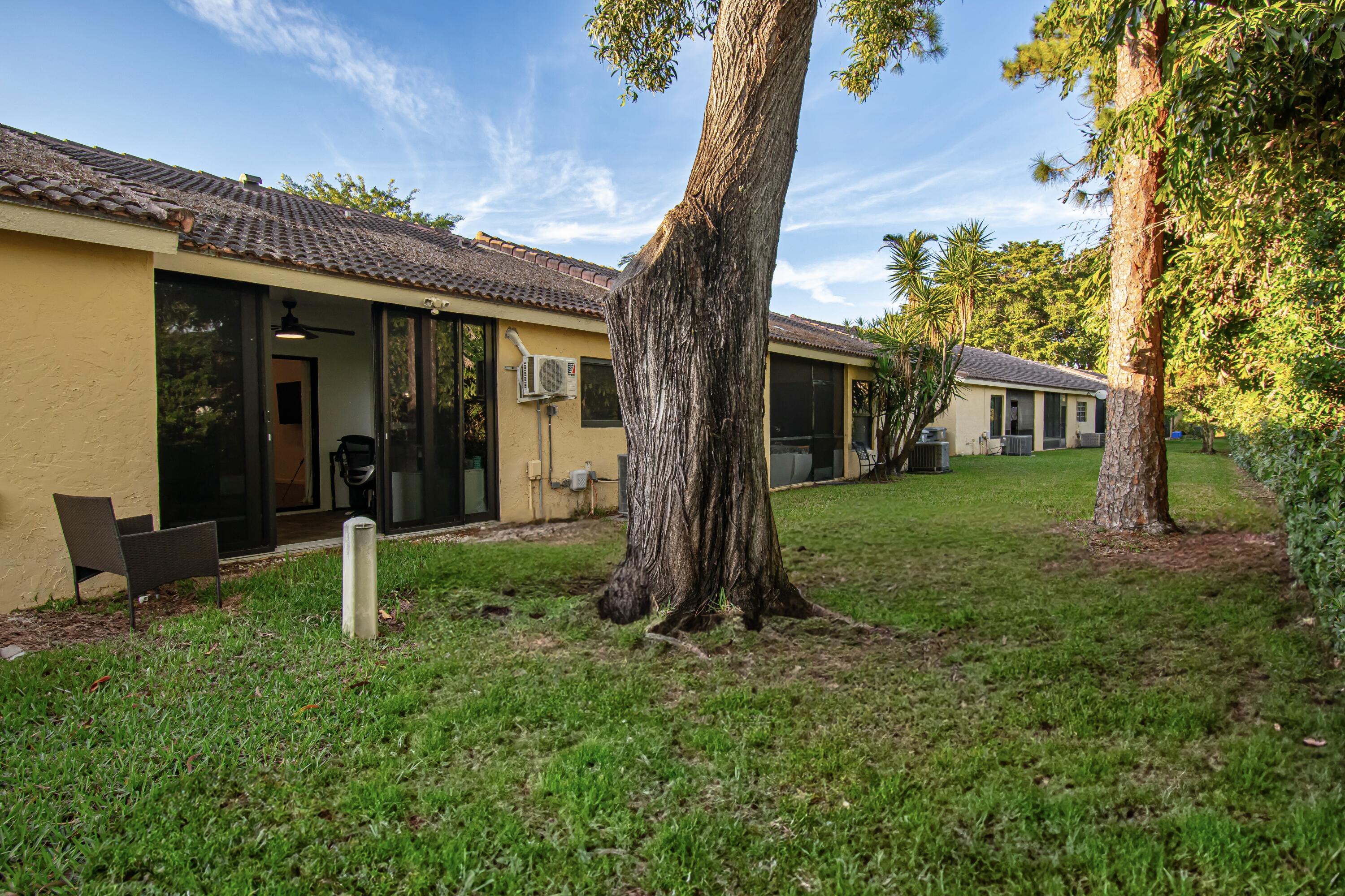 6825 Bridlewood Court Boca Raton, FL 33433 - Photo 29 of 31 a view of a house with backyard and a tree