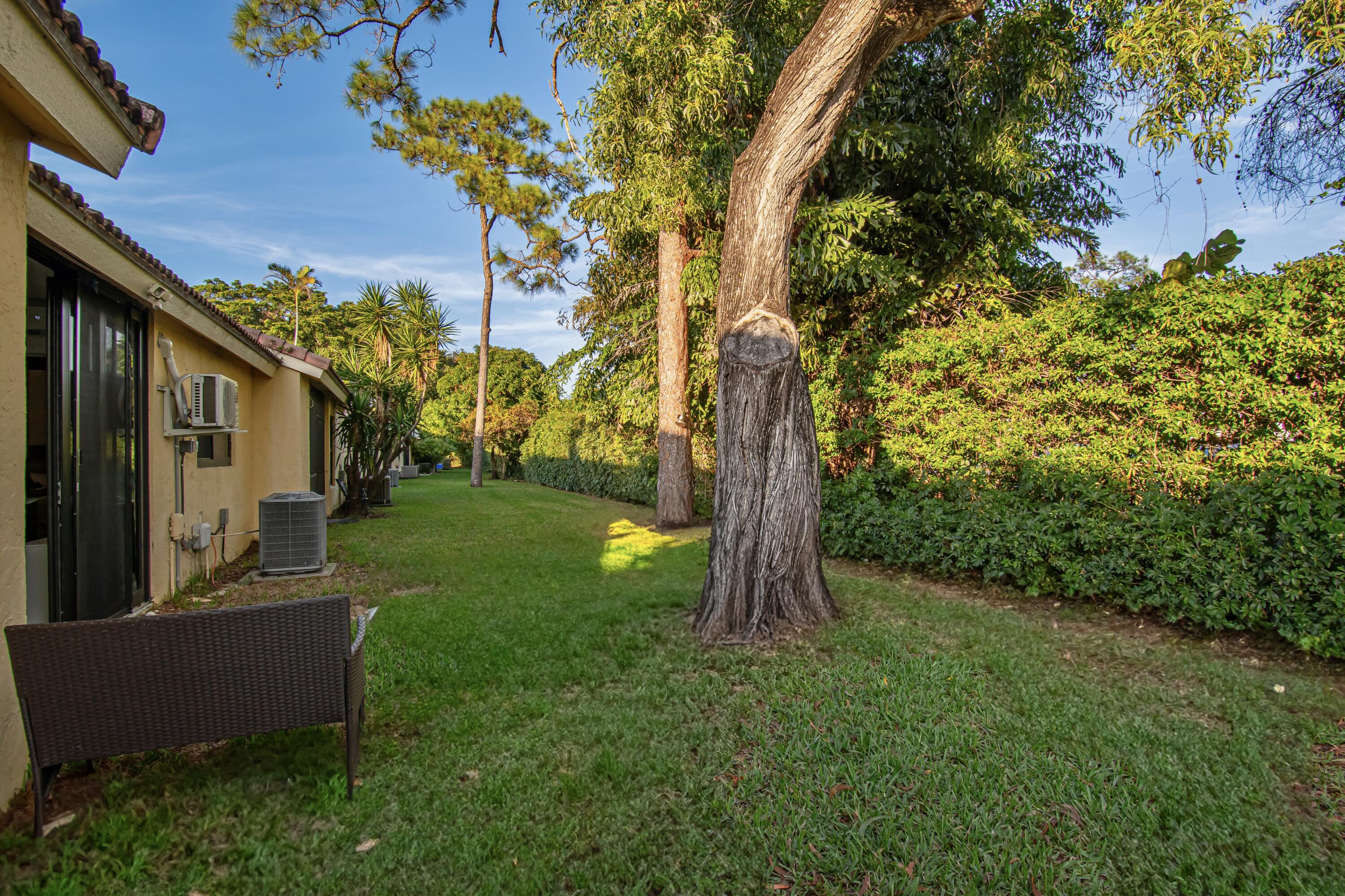 6825 Bridlewood Court Boca Raton, FL 33433 - Photo 30 of 31 a backyard of a house with table and chairs
