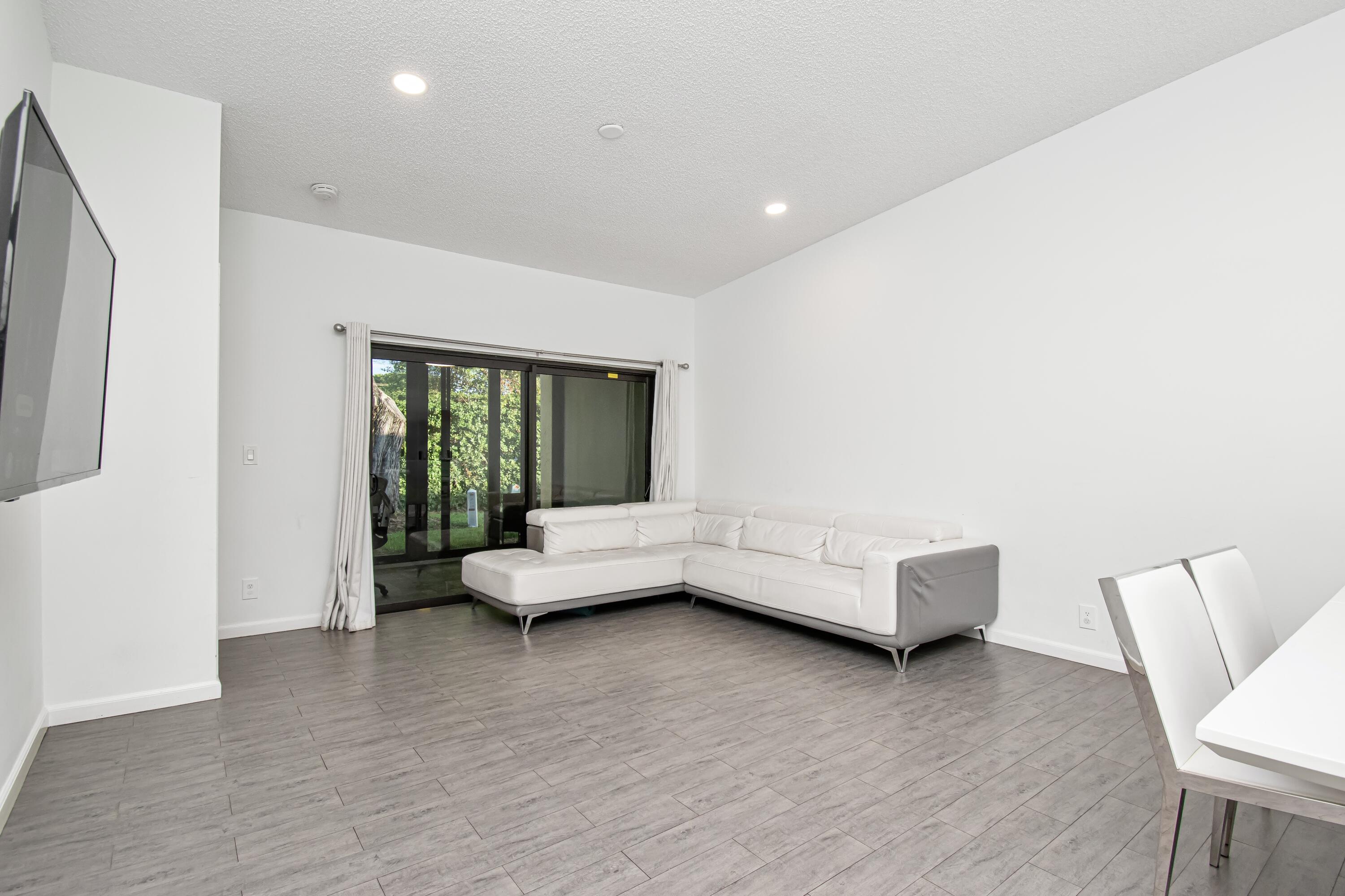 6825 Bridlewood Court Boca Raton, FL 33433 - Photo 6 of 31 a living room with furniture and a large window