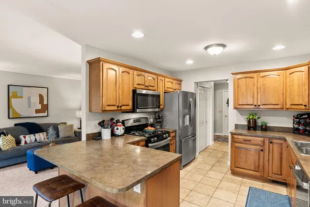 a kitchen with sink refrigerator and large window