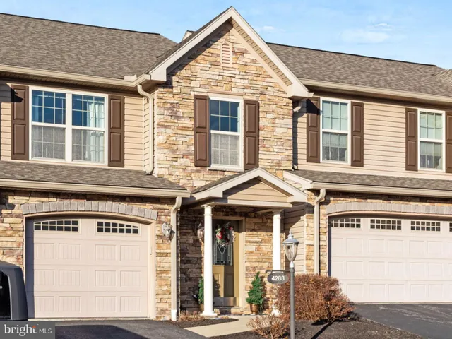 a view of a brick house with large windows