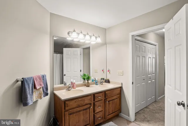 a bathroom with a sink double vanity and a mirror